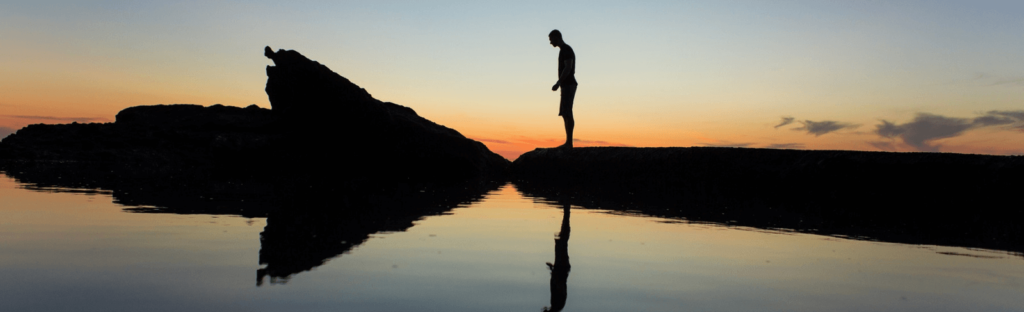 silhouette of man at sunset on laguna beach