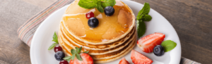 stack of pancakes with fruit on top