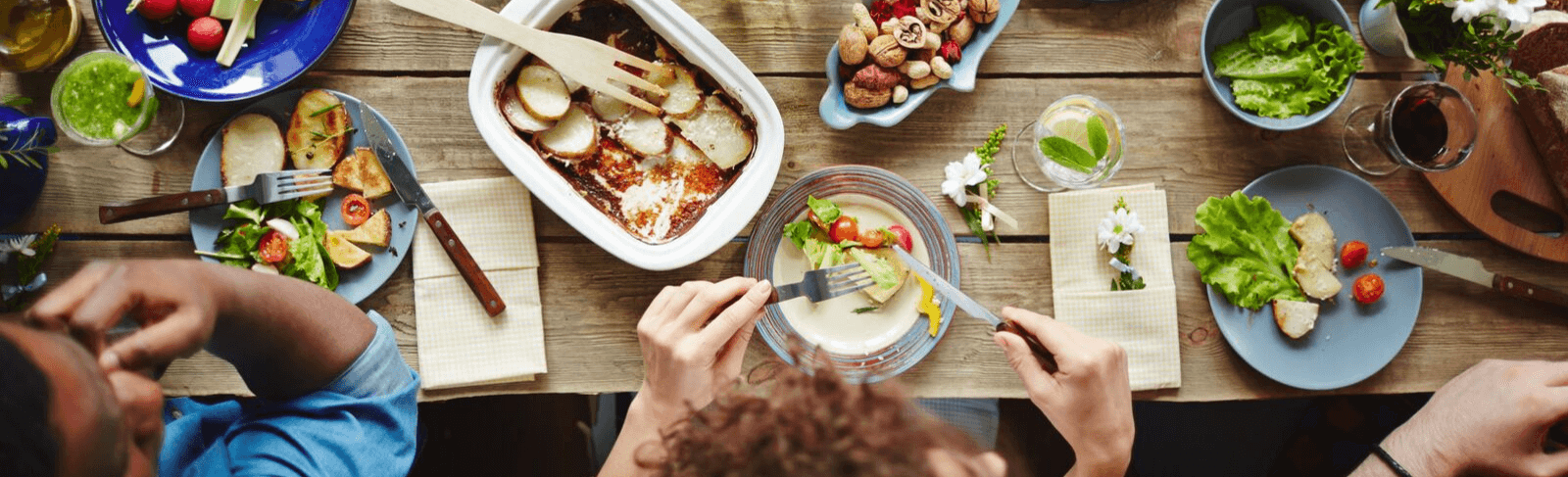 birds eye view of people eating at table full of food