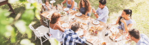 multigenerational outdoor gathering around table