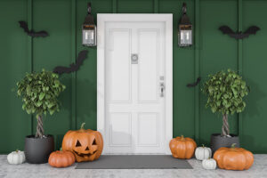 pumpkins on ground around white front door