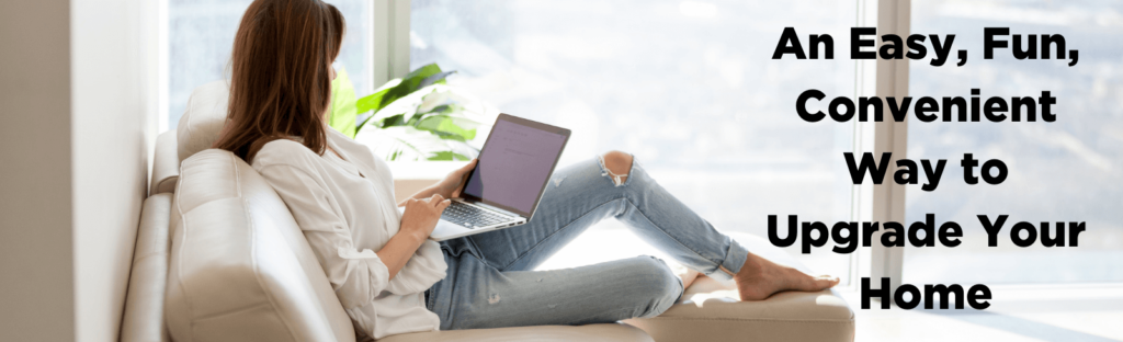 woman sits on couch looking at laptop